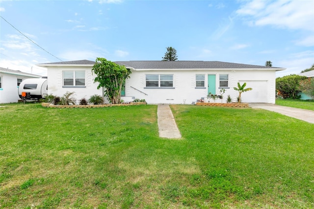 ranch-style house featuring a garage, concrete driveway, and a front yard