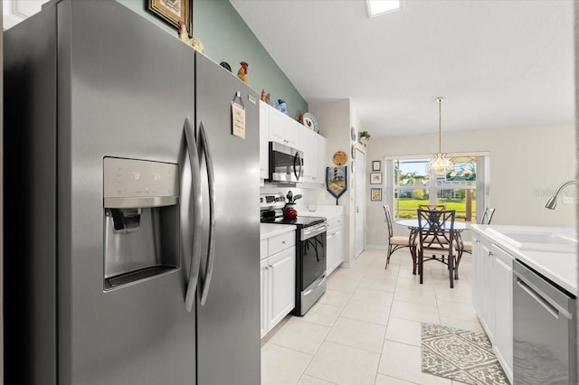 kitchen featuring a sink, light countertops, light tile patterned floors, and stainless steel appliances