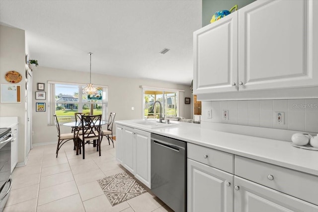 kitchen featuring light tile patterned flooring, a sink, decorative backsplash, light countertops, and stainless steel appliances