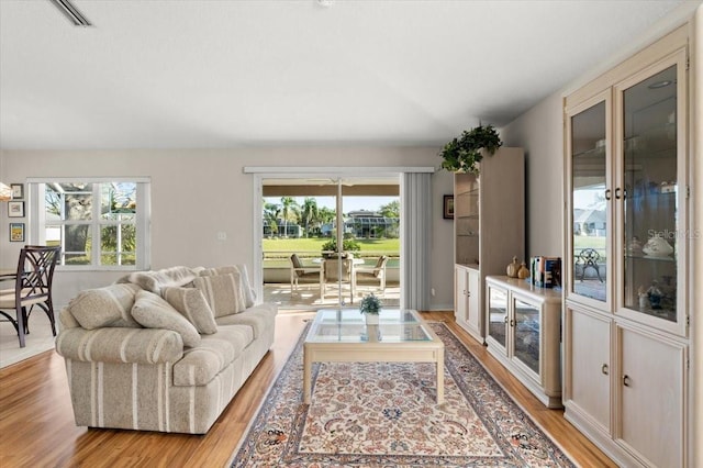 living room featuring light wood-style floors and visible vents