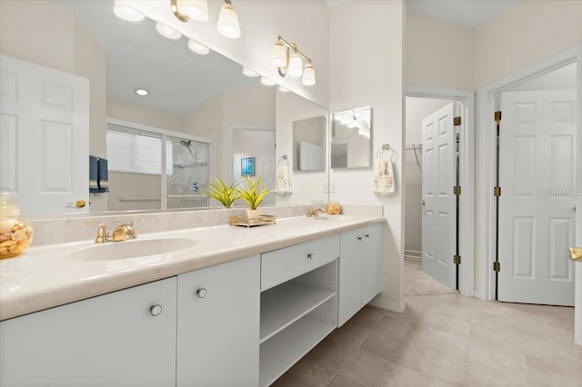 full bathroom featuring a sink, double vanity, a shower stall, and tile patterned floors