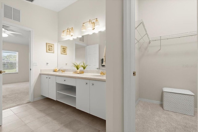 full bathroom featuring tile patterned floors, visible vents, a walk in closet, a sink, and double vanity