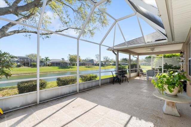 unfurnished sunroom featuring a water view