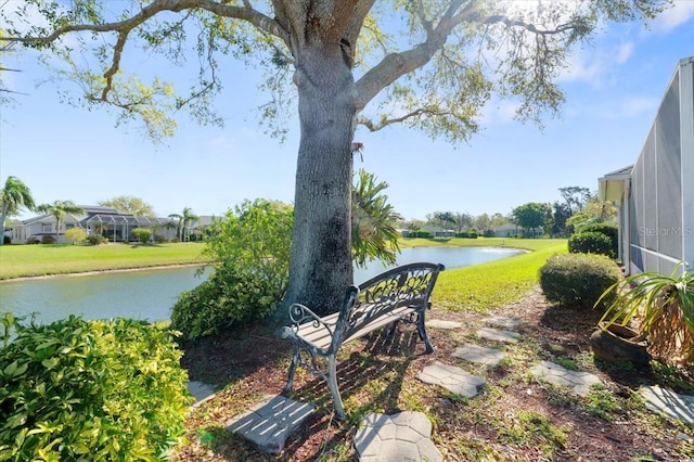 view of yard featuring a water view and a lanai