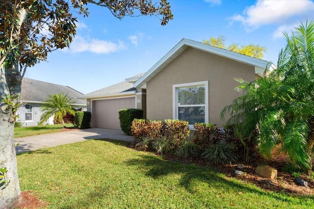 view of front facade with concrete driveway, a garage, a front yard, and stucco siding