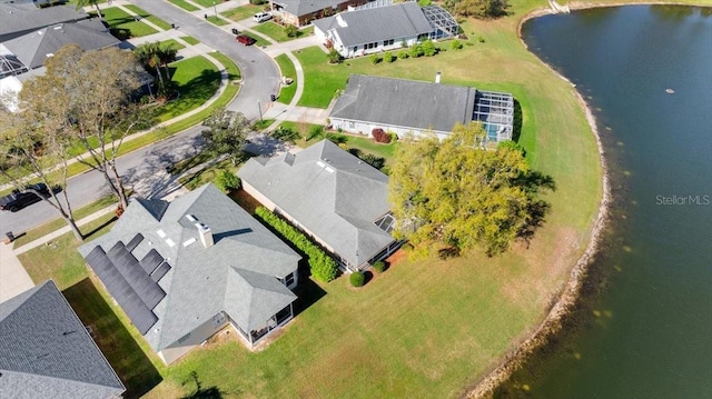 drone / aerial view with a residential view and a water view