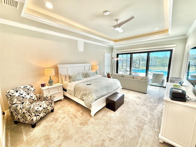 carpeted bedroom with visible vents, a ceiling fan, crown molding, a raised ceiling, and access to exterior