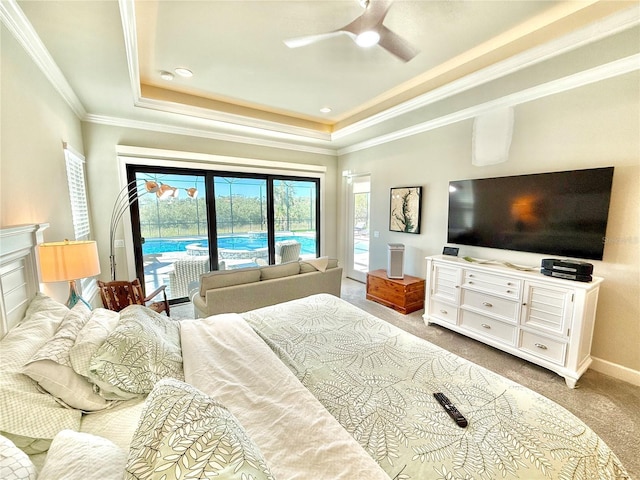 carpeted bedroom featuring a tray ceiling, access to outside, crown molding, and baseboards