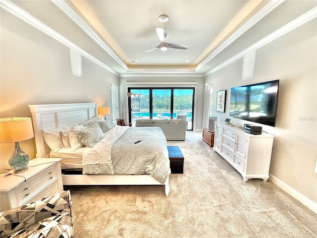 bedroom featuring a tray ceiling, baseboards, light colored carpet, and access to exterior