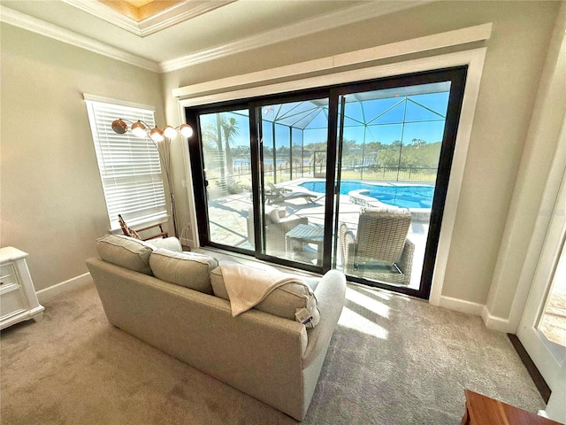 living area featuring crown molding, baseboards, a sunroom, and light carpet