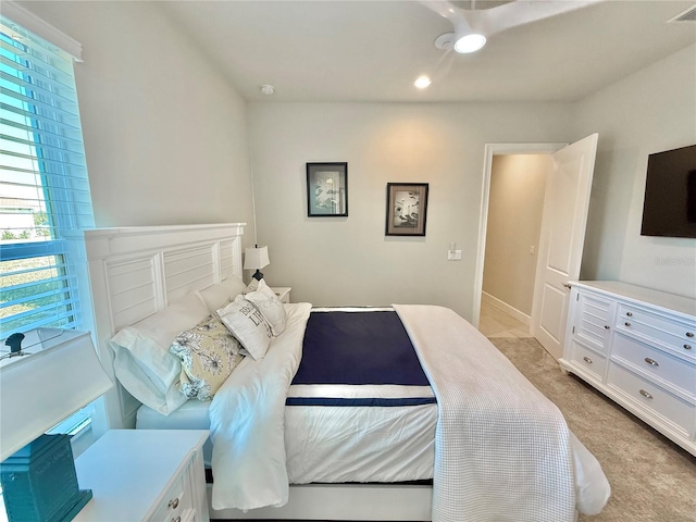 bedroom featuring visible vents and light colored carpet