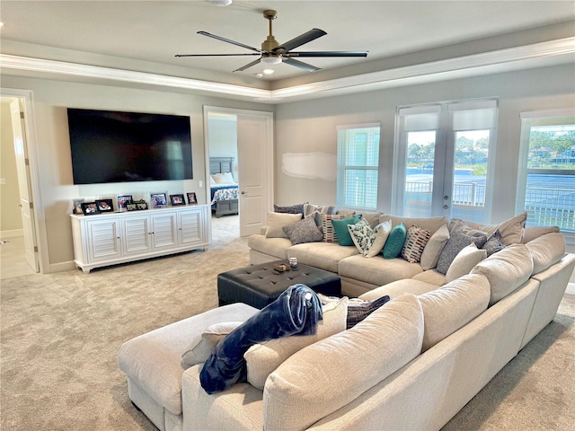 living area with baseboards, carpet floors, a tray ceiling, ceiling fan, and french doors