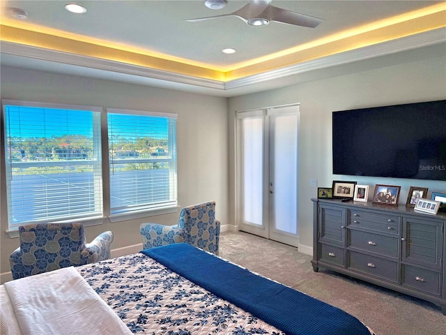 bedroom with baseboards, carpet floors, a tray ceiling, recessed lighting, and french doors