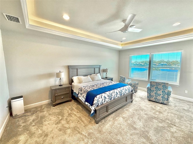 bedroom featuring visible vents, a raised ceiling, carpet floors, and baseboards