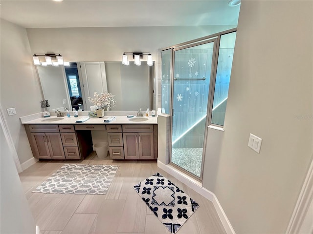 full bathroom with a sink, double vanity, and a shower stall