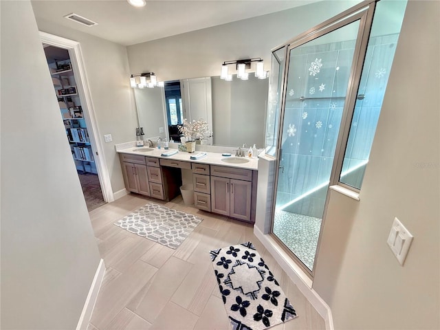 bathroom with double vanity, visible vents, a shower stall, and a sink