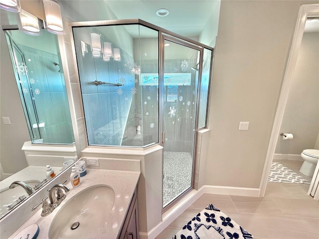 full bath with tile patterned flooring, toilet, a stall shower, and vanity