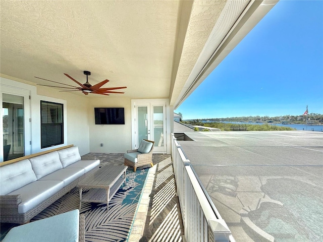 balcony with an outdoor hangout area and a ceiling fan