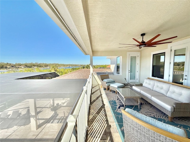 balcony featuring an outdoor living space and ceiling fan