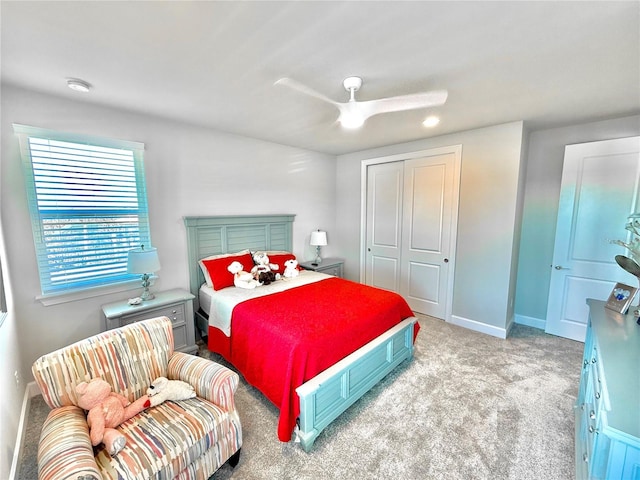 bedroom with a closet, baseboards, carpet, and a ceiling fan