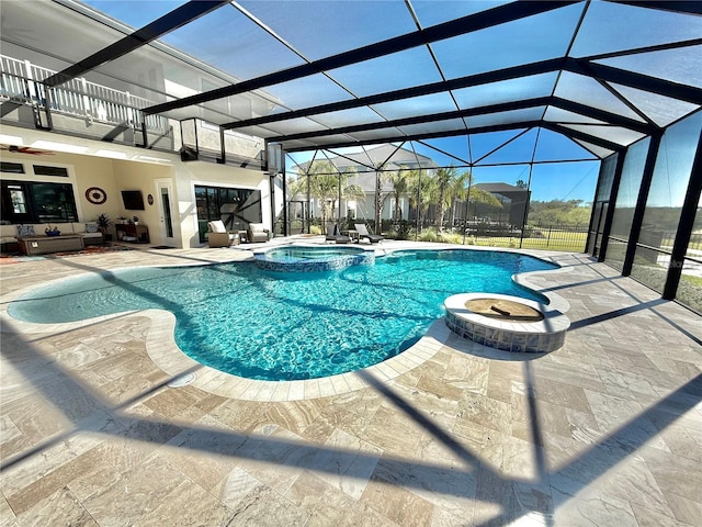 view of pool featuring glass enclosure, a pool with connected hot tub, ceiling fan, a patio area, and an outdoor hangout area