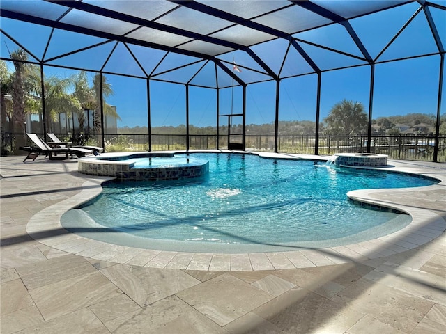 view of swimming pool featuring a patio, a pool with connected hot tub, and a lanai