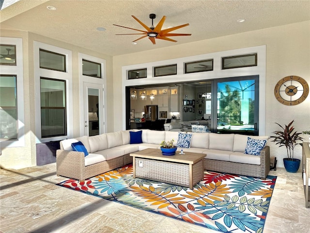 interior space with ceiling fan and an outdoor hangout area