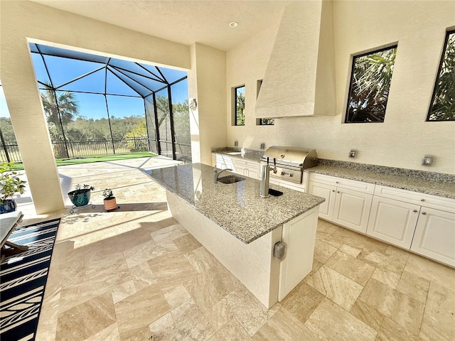 view of patio featuring a sink, area for grilling, a lanai, and a grill