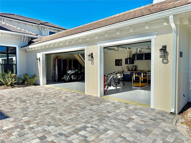 garage featuring decorative driveway