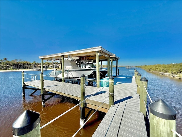 dock area with boat lift and a water view