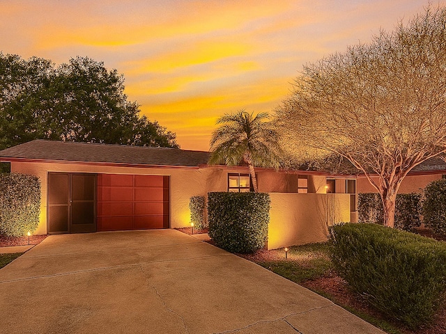 83 Farragut Dr, Palm Coast, FL 32137 - view of front of property featuring driveway, an attached garage, and stucco siding