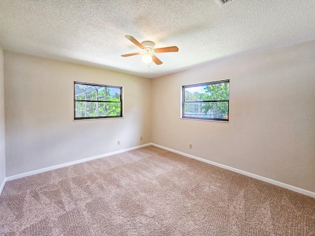 83 Farragut Dr, Palm Coast, FL 32137 - empty room with healthy amount of natural light, light carpet, ceiling fan, and a textured ceiling
