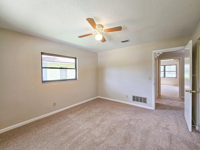 83 Farragut Dr, Palm Coast, FL 32137 - empty room featuring a ceiling fan, carpet floors, and a textured ceiling