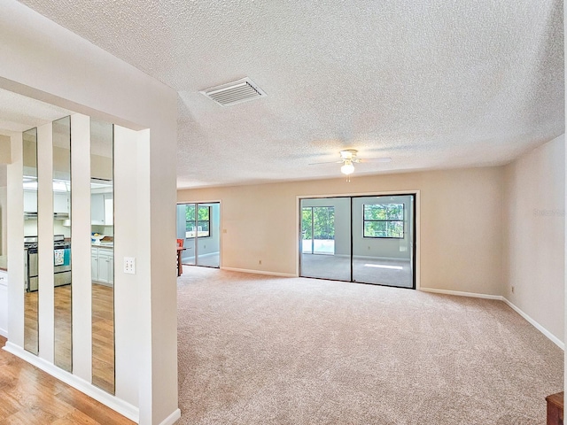 83 Farragut Dr, Palm Coast, FL 32137 - empty room with a textured ceiling, ceiling fan, and light colored carpet