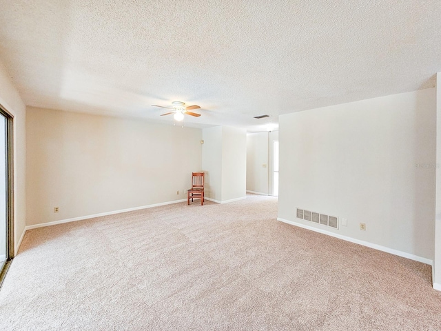 83 Farragut Dr, Palm Coast, FL 32137 - spare room featuring a ceiling fan, light carpet, and a textured ceiling