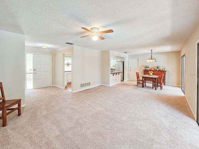 83 Farragut Dr, Palm Coast, FL 32137 - living area with a ceiling fan, light carpet, a chandelier, and a textured ceiling