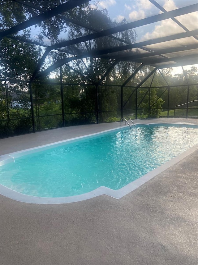 83 Farragut Dr, Palm Coast, FL 32137 - swimming pool featuring glass enclosure and a patio area