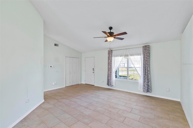 unfurnished room featuring visible vents, lofted ceiling, baseboards, and a ceiling fan