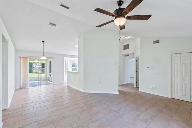 spare room with visible vents, baseboards, ceiling fan, and vaulted ceiling