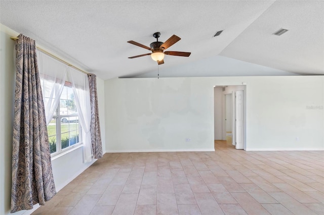 spare room with visible vents, baseboards, lofted ceiling, a textured ceiling, and a ceiling fan