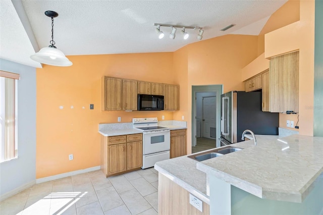 kitchen with electric range, a sink, freestanding refrigerator, black microwave, and lofted ceiling