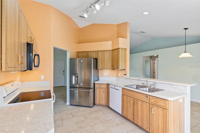 kitchen featuring white appliances, a peninsula, light countertops, and a sink