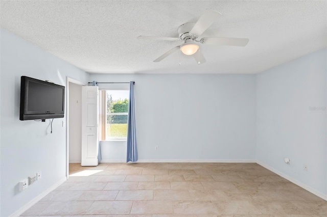 unfurnished room with baseboards, a textured ceiling, and ceiling fan