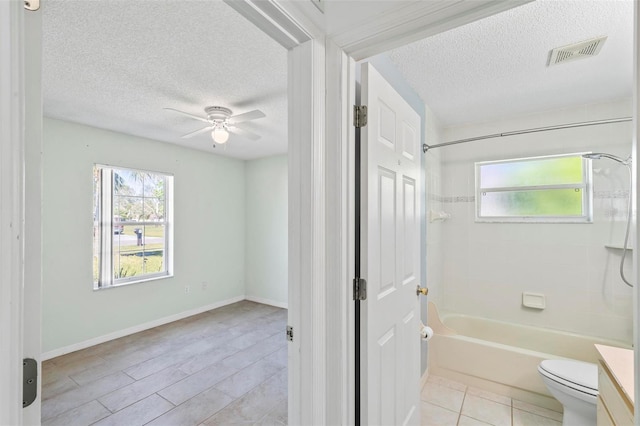 bathroom featuring a textured ceiling, tub / shower combination, visible vents, and ceiling fan