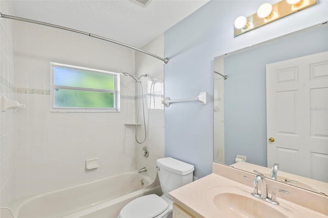 bathroom featuring toilet, a textured ceiling, washtub / shower combination, and vanity