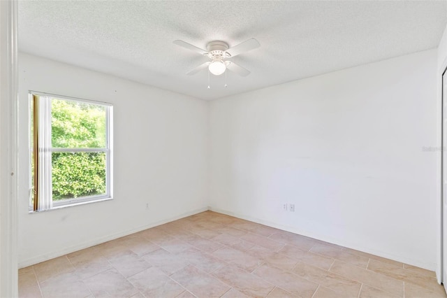 unfurnished room with baseboards, a textured ceiling, and a ceiling fan