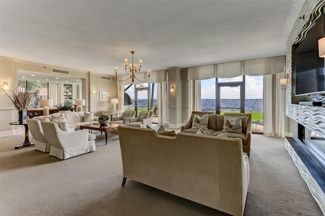 2970 Saint Johns Ave Unit 3F, Jacksonville, FL 32205 - living room featuring visible vents, carpet floors, a textured ceiling, and a chandelier