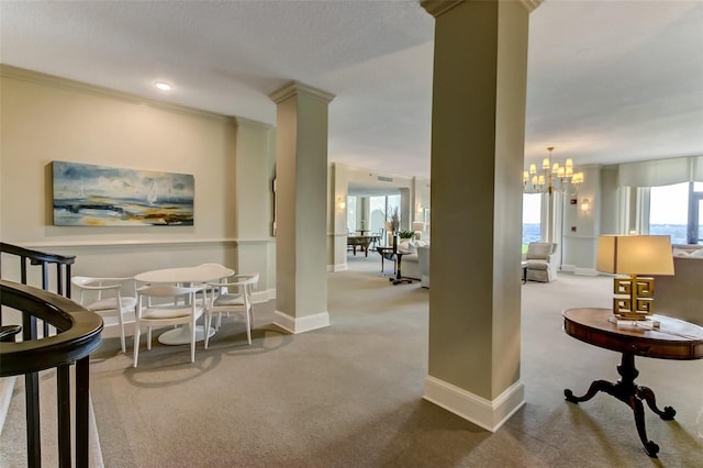 2970 Saint Johns Ave Unit 3F, Jacksonville, FL 32205 - carpeted dining area with a notable chandelier, plenty of natural light, baseboards, and decorative columns