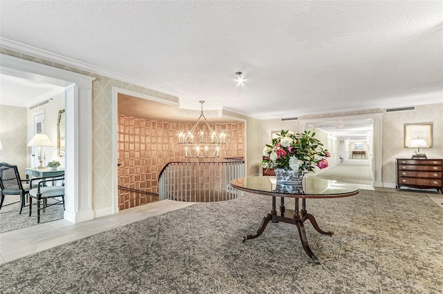 2970 Saint Johns Ave Unit 3F, Jacksonville, FL 32205 - dining space with visible vents, a textured ceiling, an inviting chandelier, crown molding, and wallpapered walls