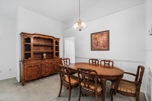 dining area featuring vaulted ceiling, light colored carpet, and a chandelier